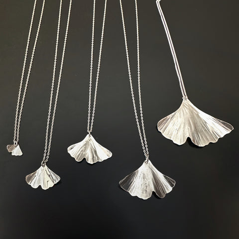 Sterling silver ginkgo leaf pendant necklaces in five different sizes.