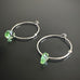 handmade sterling silver hoop earrings with a small peridot green Austrian crystal teardrop