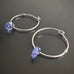 handmade sterling silver hoop earrings with a small tanzanite purple Austrian crystal teardrop