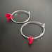 handmade sterling silver hoop earrings with a small cherry red Austrian crystal teardrop