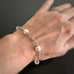 8mm white round crystal pearls set in a silvery 3.5 mm rolo chain bracelet