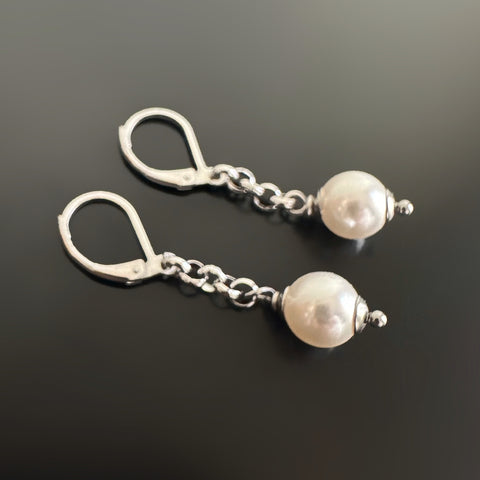 surgical steel lever-back style drop earrings with an 8mm white crystal pearl hanging from a silvery rolo chain.