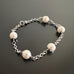 classic white round crystal pearls set within a 3.5 mm rolo style surgical steel chain.