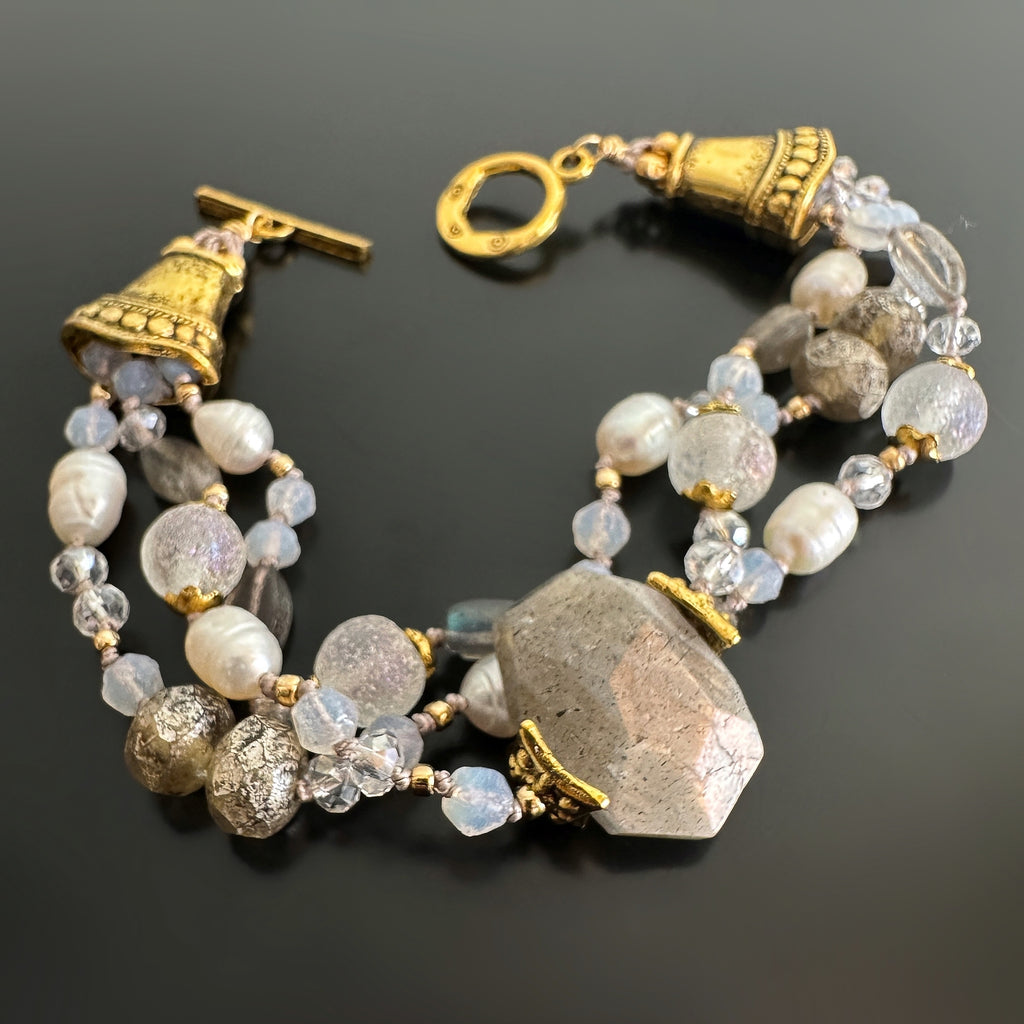 Three-strand hand-knotted bracelet with white freshwater pearls, labradorite, glass and golden accents.
