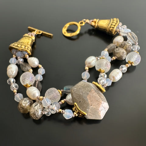 Three-strand hand-knotted bracelet with white freshwater pearls, labradorite, glass and golden accents.