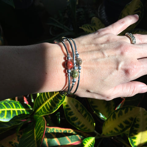 Set of three warm earth tone stone stretch stacking bracelets in silver.