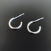 handmade half hoop post earrings made in sterling silver with hammered texture