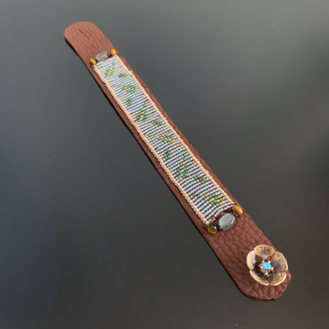 Brown leather strap bracelet with hand woven seed beads and flower button clasp