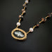 hand painted canvas of dove set in brass with a textured frame.  The necklace chain is ocean jasper and white freshwater pearls.
