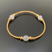gold tube stretch bangle bracelet with white ancient looking glass