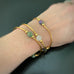 your choice of three stretch gold tube bangle bracelets with green, white or purple ancient looking glass