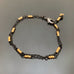 double strand adjustable length bracelet made with black chain and gold beads