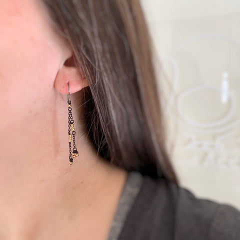 delicate and lace like earrings with black chain and gold beads