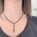 y shaped necklace with black chain and silver accents creating a lace like feeling