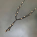 silver peaded black chain Y necklace with a double drop in a lace like pattern