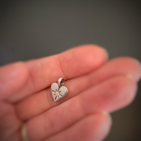 Light Hearted, pendant in sterling silver with white sapphire and cross on reverse