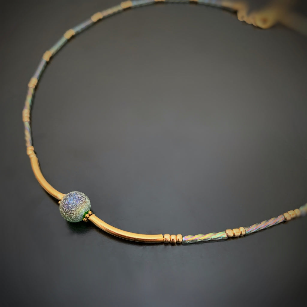 ancient looking green glass focal on this adjustable length choker adorned with twisted column glass beads