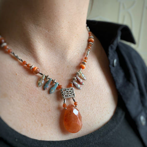 orange quartz teardrop necklace with polka dot fan beads and orange cat's eye glass