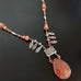 orange quartz faceted teardrop necklace with cats eye glass and fan style shape