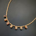 earthy glass teardrops adorn this gold accented adjustable length choker necklace