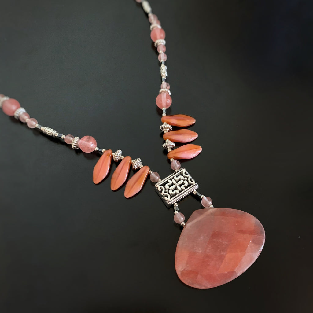 salmon pink teardrop pendant with filigree focal and fan style fringe beads