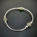 silver tube stretch bangle bracelet with ancient looking green glass