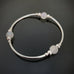 silver tube stretch bangle bracelet with ancient looking white glass