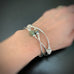 set of three silver tube stretch bangle bracelets with ancient looking glass in green, purple and white
