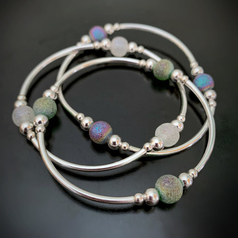 set of three stretch silver tube bangle bracelets with ancient looking glass in white, purple and green