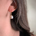large white baroque pearl earrings in gold