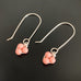 Sterling silver drop earrings with delicate peachy pink coral colored beads in a triplet formation. 