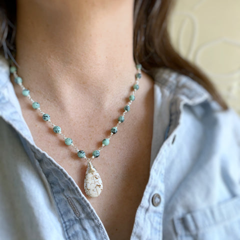 hand made link necklace with a creamy teardrop pendant and speckled turquoise glass