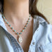 hand made link necklace with a creamy teardrop pendant and speckled turquoise glass