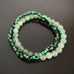 Pair of stretch bracelets, one in green aventurine, and one in green and black striped glass