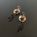 gold brass cherry blossom flower earrings with black teardrop dangles