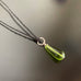 olivine green glass pendant necklace with twisted ring accent