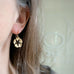 gold cherry blossom dangle earrings with black accents