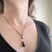 black glass teardrop pendant necklace with twisted circle loop