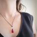 red teardrop glass pendant necklace with silver twisted loop