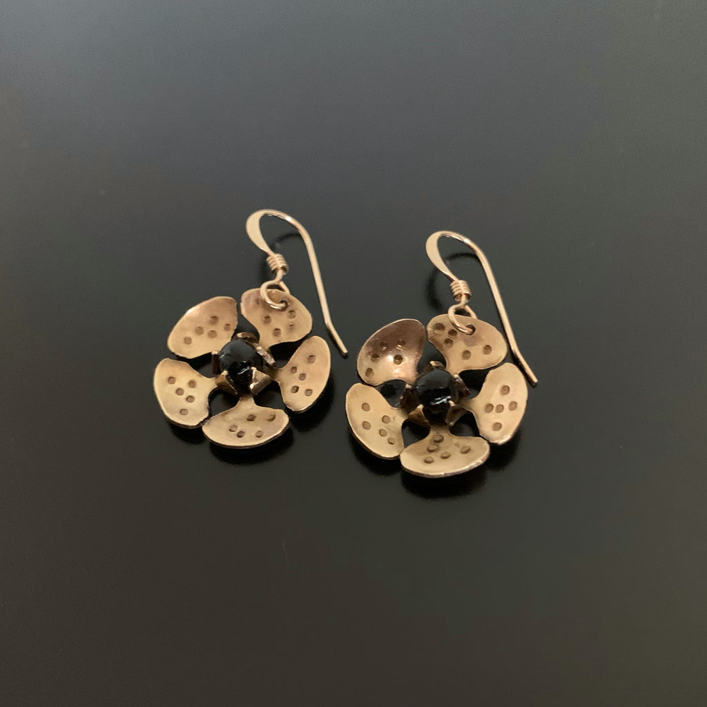 gold brass cherry blossom flower dangle earrings with black accents in the center
