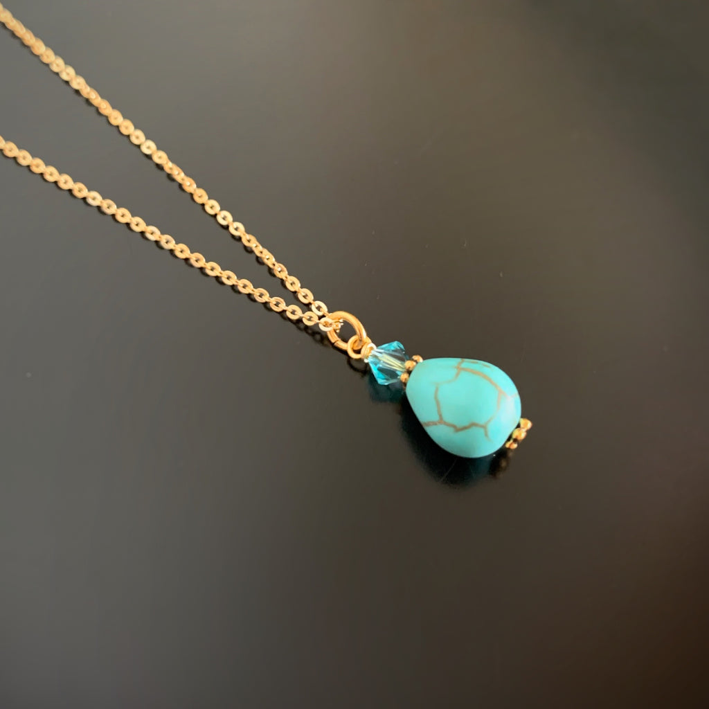 turquoise teardrop pendant with crystal accent on gold plated chain