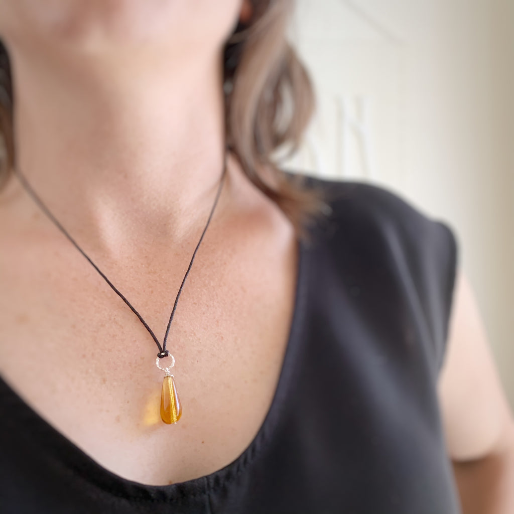 amber colored tear drop glass pendant necklace with twisted silver wire ring