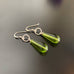 olivine green glass teardrop earrings with textured circle accent