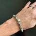 gold brass ginkgo charm on dalmatian jasper stretch bracelet