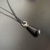 jet black teardrop pendant necklace with silver twisted wire ring accent