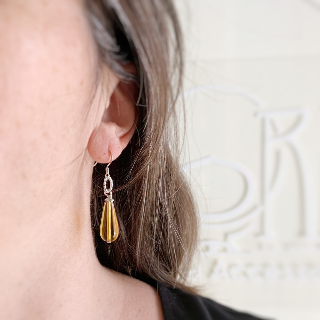 amber glass teardrop earrings with sterling silver ear wires and twisted circle motif