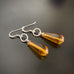 amber color glass teardrop earrings with sterling silver wires and twisted circle loop