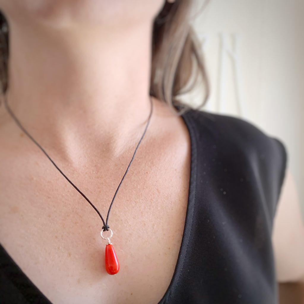 opaque red teardrop pendant necklace on black cord