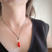 opaque red teardrop pendant necklace on black cord