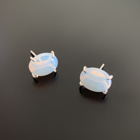 Opalescent moonstone color glass oval, sterling silver prong set post earrings.